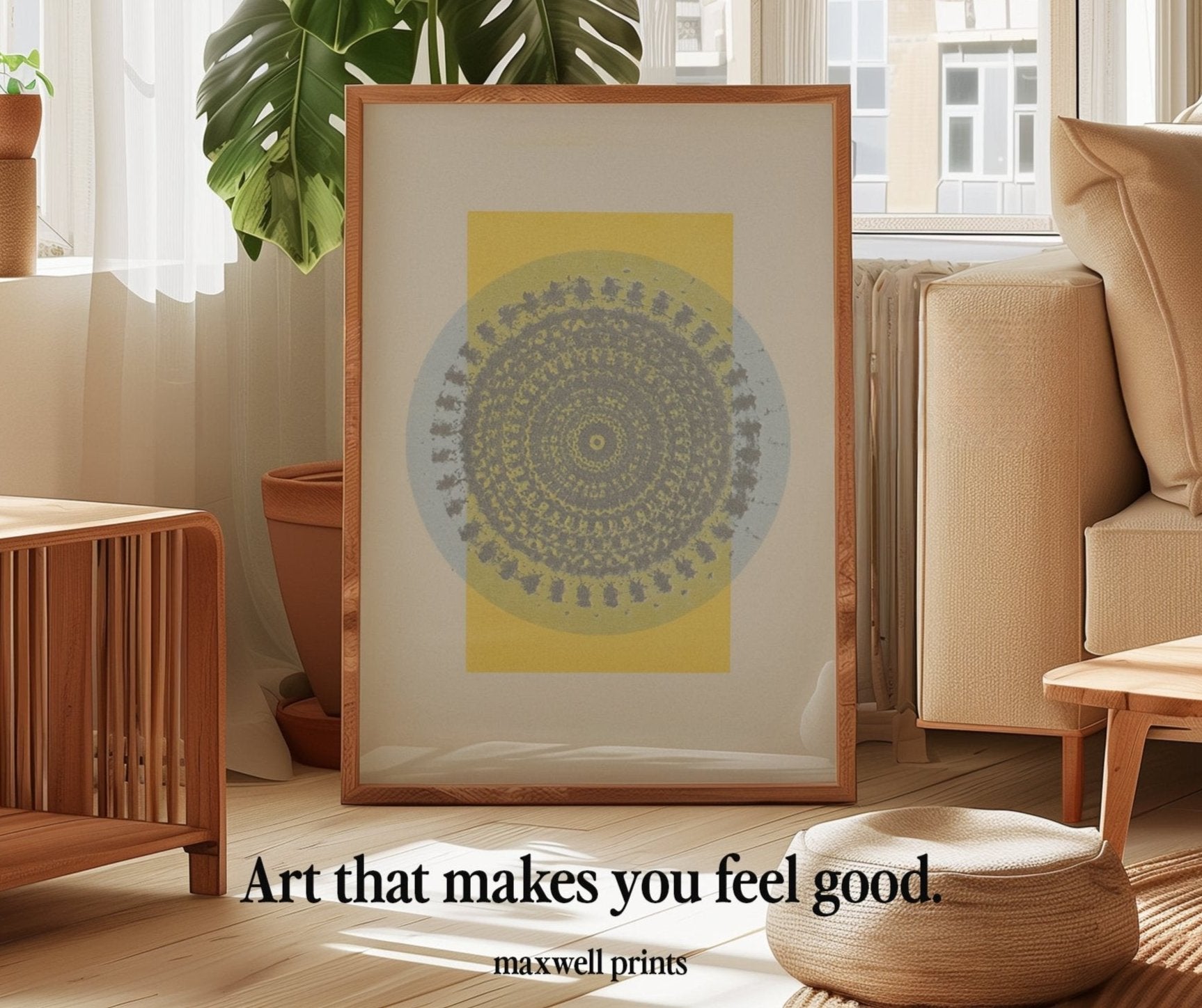 Framed mandala wall art print with intricate geometric patterns in soft yellow and gray tones, displayed in a bright, minimalist living room with boho decor. The modern art print adds a calming, meditative vibe to the space, perfect for those seeking unique and uplifting home decor. Styled with natural wood furniture, indoor plants, and soft neutral tones, the scene captures the essence of minimalist artwork by Maxwell Prints.